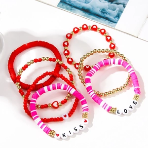Detail view of 7-piece bohemian beaded bracelet set with LOVE and KISS letters