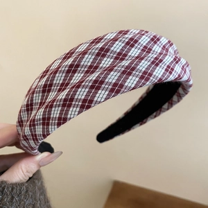 Detailed view of red and white checkered fabric headband with non-slip black lining