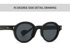 Close-up of black retro round sunglasses featuring golden arrow rivets and thick frames