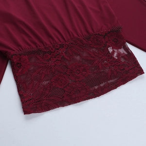 Close-up of wine red lace stitching detail on the hem of a sexy off-shoulder top