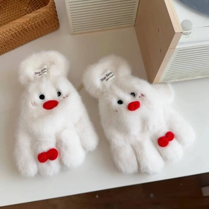 Detail of plush white bear mittens with red bows and embroidered brand labels