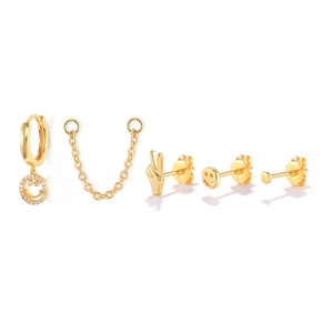 Close-up of gold S925 silver earring set featuring smiley face charms and zirconia studs