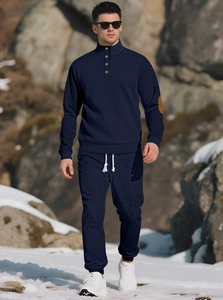 Detail of navy knit sweatshirt with brown elbow patches and diamond texture in outdoor setting