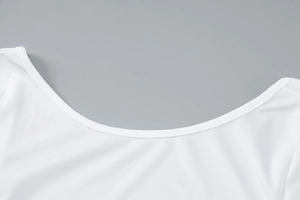 Close-up of the delicate neckline and fine stitching on the white bodycon maxi dress