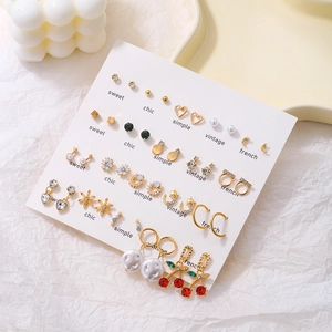 Detailed set of diverse earrings with pearls and rhinestones on white display card