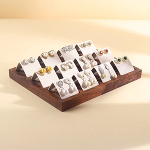 Walnut wood earring display stand with twelve cream velvet studs and earring holders