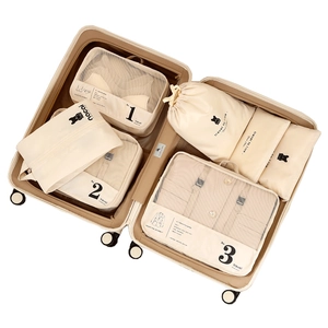 Minimalist beige travel storage bag set with mesh cubes and numbered organizers for luggage