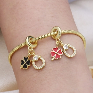 18k gold plated snake chain bracelet featuring colorful clover and horseshoe charms