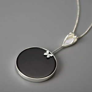 Elegant S925 silver butterfly pendant with black disc and iridescent mother of pearl