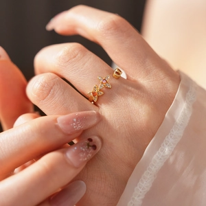 Detail eines vergoldeten Vintage-Rings mit orangem Zirkon und Schmetterling-Motiv