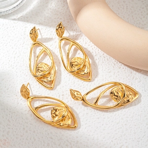 Golden hollow teardrop earrings with textured hammered finish in artistic style
