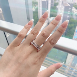 Close-up of S925 silver eternity ring with rectangular zircons worn on finger