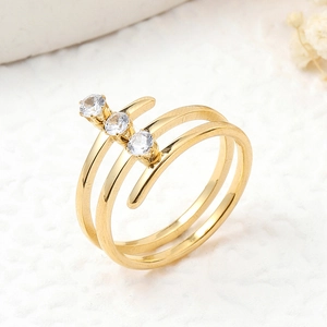 Detailed close-up of a multi-layer gold stainless steel ring with three clear gemstones