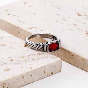 Macro shot of silver cable ring with rectangular red gemstone in vintage pavé setting