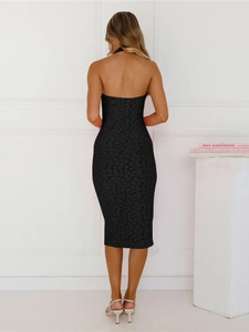 Detail of elegant backless halter neck dress in black floral jacquard fabric