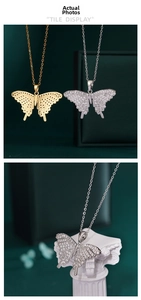 Close-up of gold and silver butterfly pendants with micro-paved zircons on greek columns