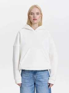 Oversize white hoodie for women featuring a minimalist loose fit and kangaroo pocket