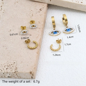 Detailed set of gold evil eye stud earrings with blue beads and hammered metal texture