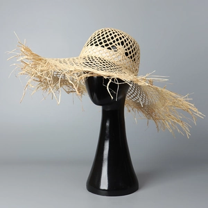 Hollowed-out summer straw sun hat with frayed wide brim for beach vacation and sun shade