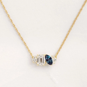 Luxurious gold birthstone necklace featuring emerald and marquise cut zircon pendant