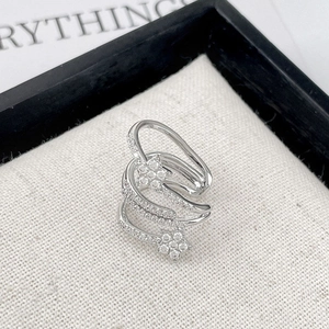 Chic multi-layered silver star ring with white zircon stones on a woven texture background
