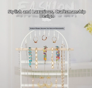 Detailed view of white arch metal earring organizer with a natural wooden support bar
