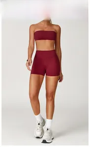 Front view of model wearing cherry red brushed sports bra and high-waisted gym shorts set