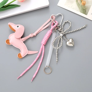 Detail view of pink leather dachshund charm with woven rope and silver heart carabiner