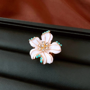 Close-up of vintage flower ring with white petals, blue beads and clear crystals