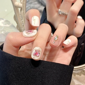 Short milky white press-on nails with 3D pink butterflies and pearl accents