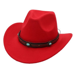 Detail of red cowboy hat with brown leather band and turquoise stone embellishments