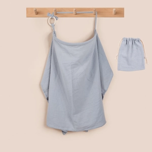 Close-up of light blue cotton nursing cover with adjustable strap and storage bag