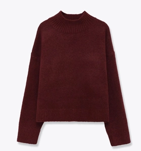 Close-up of deep wine red mock neck knit sweater with soft ribbed texture and drop shoulders