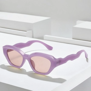 Fashionable square purple sunglasses with wavy temples and pink lenses on white blocks