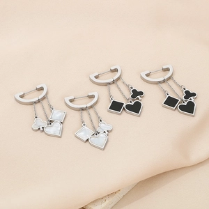 Detail of playing card suit charms in black and white shell on silver chains