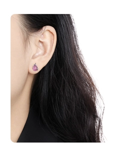 Detail view of water drop earrings with pink-purple gemstones and silver plating