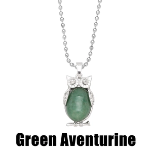 Detail of silver owl necklace featuring a large oval green aventurine stone inlay