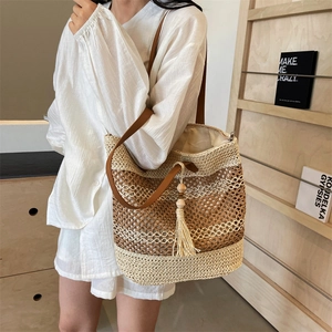 Woven straw shoulder bag with beige and brown hollow texture and stylish tassel detail