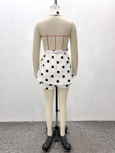 Detail view of the halter neck backless design with black and white polka dot print