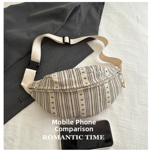 Detail of striped fabric chest bag with adjustable strap and buckle closure