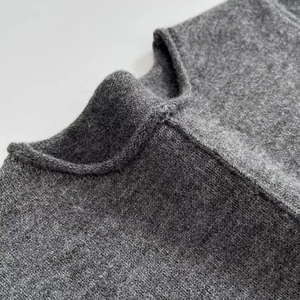 Close-up of the grey knit crewneck short sleeve mini dress showing fabric texture