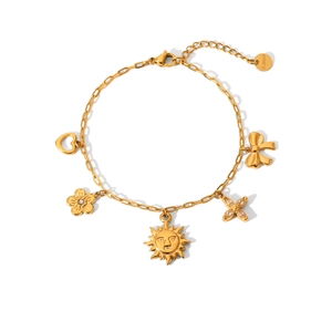 Gold plated stainless steel bracelet with heart, flower, sun and bow pendants on white base