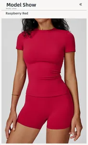 Detail of raspberry red slim fit yoga set featuring short sleeve top and high waist shorts