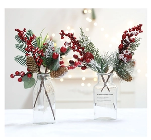 Close-up of artificial Christmas pine needles with red berries and natural pine cones