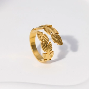 Close-up of golden stainless steel adjustable ring with detailed feather ends