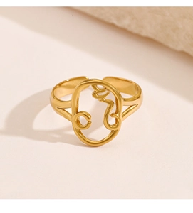 Close-up of gold hollow face design ring with 18K plating and abstract line art
