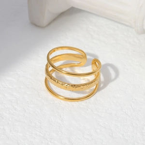Detail of gold multilayer open ring showing unique hammered texture and metallic finish
