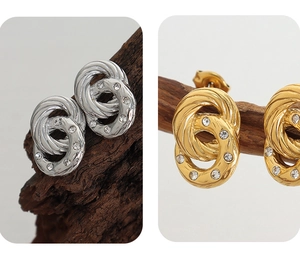 Macro shot of double-loop twisted earrings with zircons on vintage wood texture