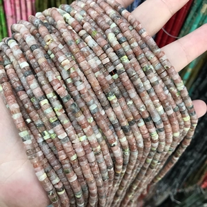 Macro detail of 2x4mm natural stone tube beads in pink and peach for DIY jewelry