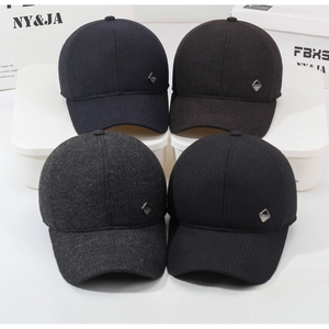 Detail showing four colors of men's winter caps with earflaps and metal diamond logo